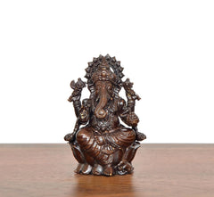 Lord Ganesha brass idol from front, seated posture with detailed jewelry and crown