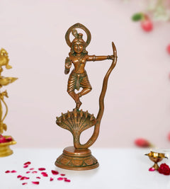 Brass Krishna dancing on Kaliya Naag figurine, ornate halo and serpent tail