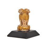 Side view of gold-toned Ashoka lion figurine with coin-like emblem on dark base