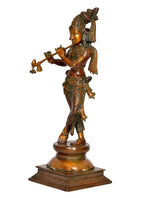 Brass Krishna statue side view, holding flute, decorated robes, pedestal base