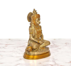 Brass Hanuman meditating idol, angled view, golden finish, hands resting in lap