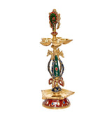 Brass diya figurine with triple-bowl holder, colorful green-blue robe and red gold base