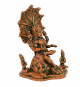 Brass Dakshinamurti Shiva statue angled view, orange seated figure with green followers