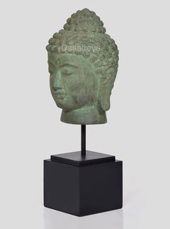 Bronze Buddha head idol on black stand, side profile view