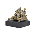 Brass Shiva Parivar deity murti from side view, four figures on dark rectangular base