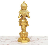 Golden brass Apsara lady figurine holding an oil lamp, back view