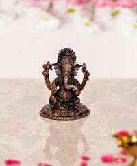 Copper Lord Ganesha idol, 2-inch seated figure with four arms and detailed crown