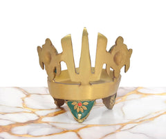 Brass diya lamp rear view with teal triangular panel and chakra-style prongs