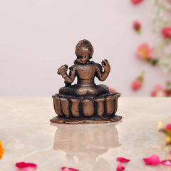 Copper Bala Tambika Sundari statue, back view showing seated posture and lotus base