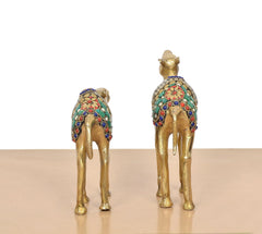 Back view of brass camel figurine pair with teal and multicolor circular detailing