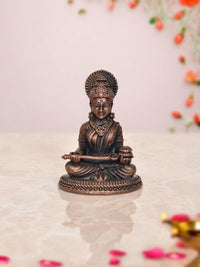 Annapurna copper decorative idol, seated goddess with ornate crown and holding an instrument