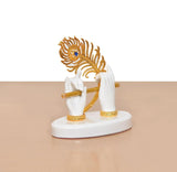 Side view: white resin hands playing golden flute, golden peacock motif on top
