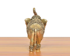 Brass elephant figurine, rear view with embossed detailing and curled tail