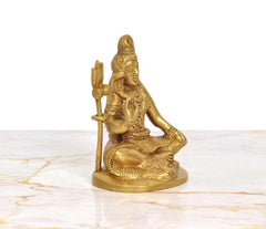 Lord Shiva brass sculpture, angled view seated in blessing pose holding trident