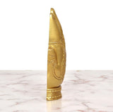 Golden brass Ganesha idol side view with carved back panel and layered base detailing.