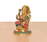 Brass Lakshmi idol statue, side angle showing red-and-green jeweled clothing and ornaments.