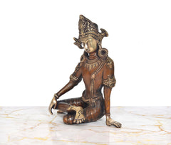 Brass Indra Devta showpiece, seated with one leg tucked and detailed jewelry accents