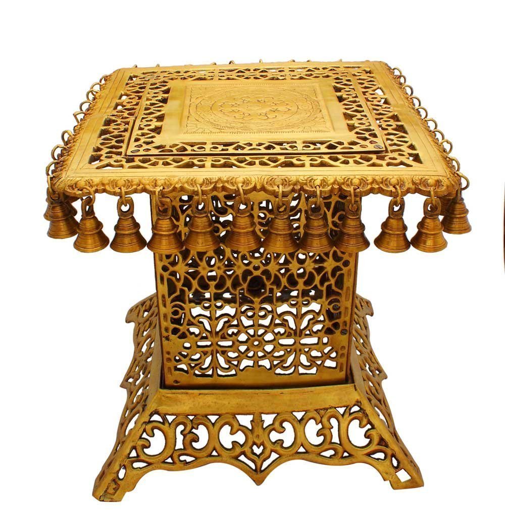 Brass table showpiece, 15-inch height, ornate top with carved panel and hanging bells
