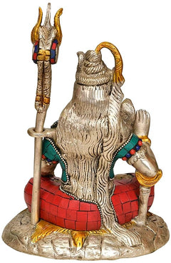 Shiva brass figurine with trident, red tiled base, teal ornament, one raised hand