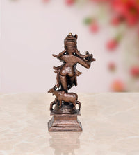 Rear three-quarter view Krishna statue with cow standing, dark bronze copper tone base