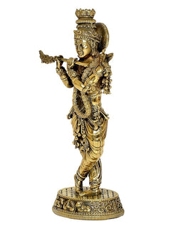 Lord Krishna brass sculpture playing flute, side pose, intricate engravings on base