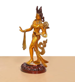 Brass Tara Devi dancing statue from side, gold figure with carved maroon round base