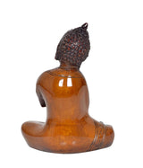 Brass Buddha statue from back view, meditating seated posture