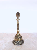 Brass pooja bell with ornate circular base, ribbed stem, Garuda top