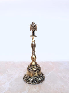 Brass pooja bell with ornate circular base, ribbed stem, Garuda top