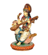 Resin Saraswati idol side view, red and blue dress, veena in hands