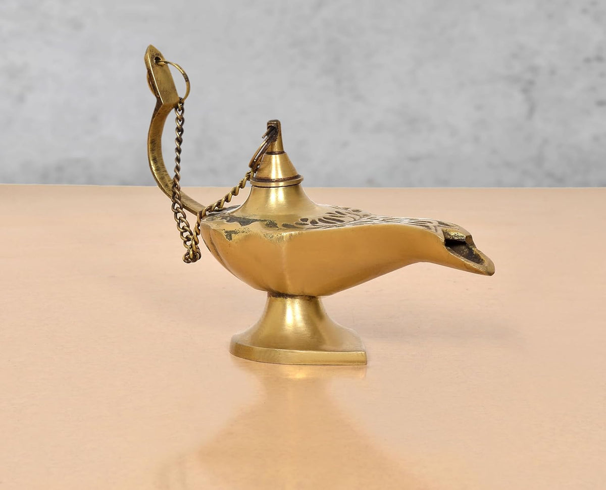 Brass Aladdin genie lamp, arched handle with chain, pointed spout and round base