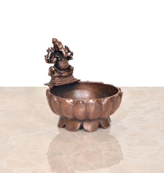 Copper Ganesha urli bowl, angled view of deity on top
