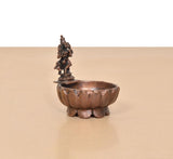 Krishna urli bowl showpiece angled view, tall deity figurine on small pedestal