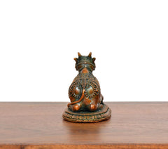 Back view of seated Nandi brass figurine with crowned head and embossed details