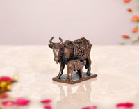 Copper cow and calf pooja mandir figurine, rear angle, patterned cloth texture