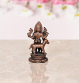 Copper Kal Bhairav idol, back view, trident and small hand-held ornaments