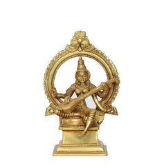 Brass Saraswati idol front view, seated veena player with ornate halo frame