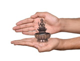 AONA copper Lakshmi Maa urli bowl, 3-inch height, shown in hands; goddess on lotus base.