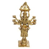 Back view gold brass figurine showing eight diya bowls around raised hands and tray