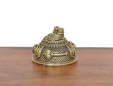 Angled brass Hanuman Charan Paduka idol with textured surface and stacked top posts