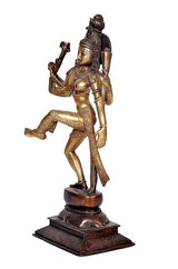 Side view brass Ardhanarishwar idol, raised arms and draped sash, dark pedestal base