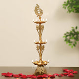 Brass diya stand with peacock topper and three tier oil lamps, 33 inch tall