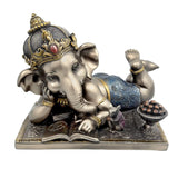 Baby Reading Ganesha resin idol in side view, trunk raised, holding offering bowl