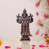 Copper Dhanvantari statue back view, ornate headpiece and raised four arms