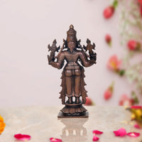 Copper Dhanvantari statue back view, ornate headpiece and raised four arms