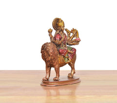 Durga Maa resin statue on lion, side view; raised hands and jeweled crown