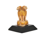 Rear view of gold-toned lion resin figurine on dark rectangular stand