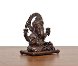 Sitting Ganesha brass idol, angled view, textured torso and detailed back