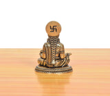 Bronze Maa Annapurna Devi figurine, rear view, seated with om-style symbol on crown