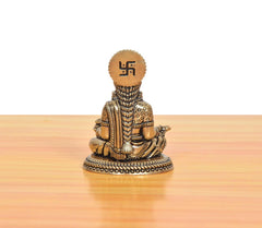 Bronze Maa Annapurna Devi figurine, rear view, seated with om-style symbol on crown